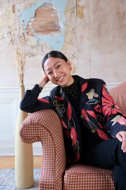 Gail Smith smiling in a leather armchair